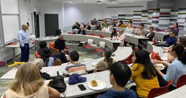 A full lecture room listening to William and a moderator
